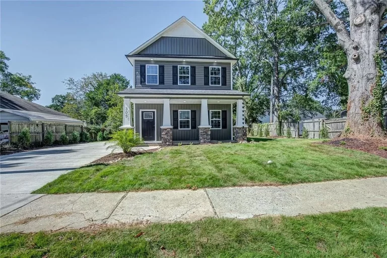 305 S. Trenton Gastonia, NC a house with a lawn and a driveway